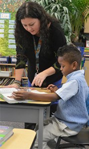 Amy Topp helps Keegan Rosses with his reading